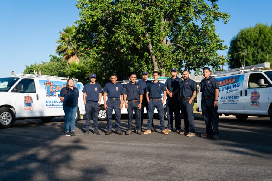 candu plumbing team in front of vans