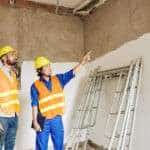 Builders discussing leaking roof